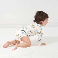 Alternate image of a child crawling wearing a Let's Explore printed bodysuit
