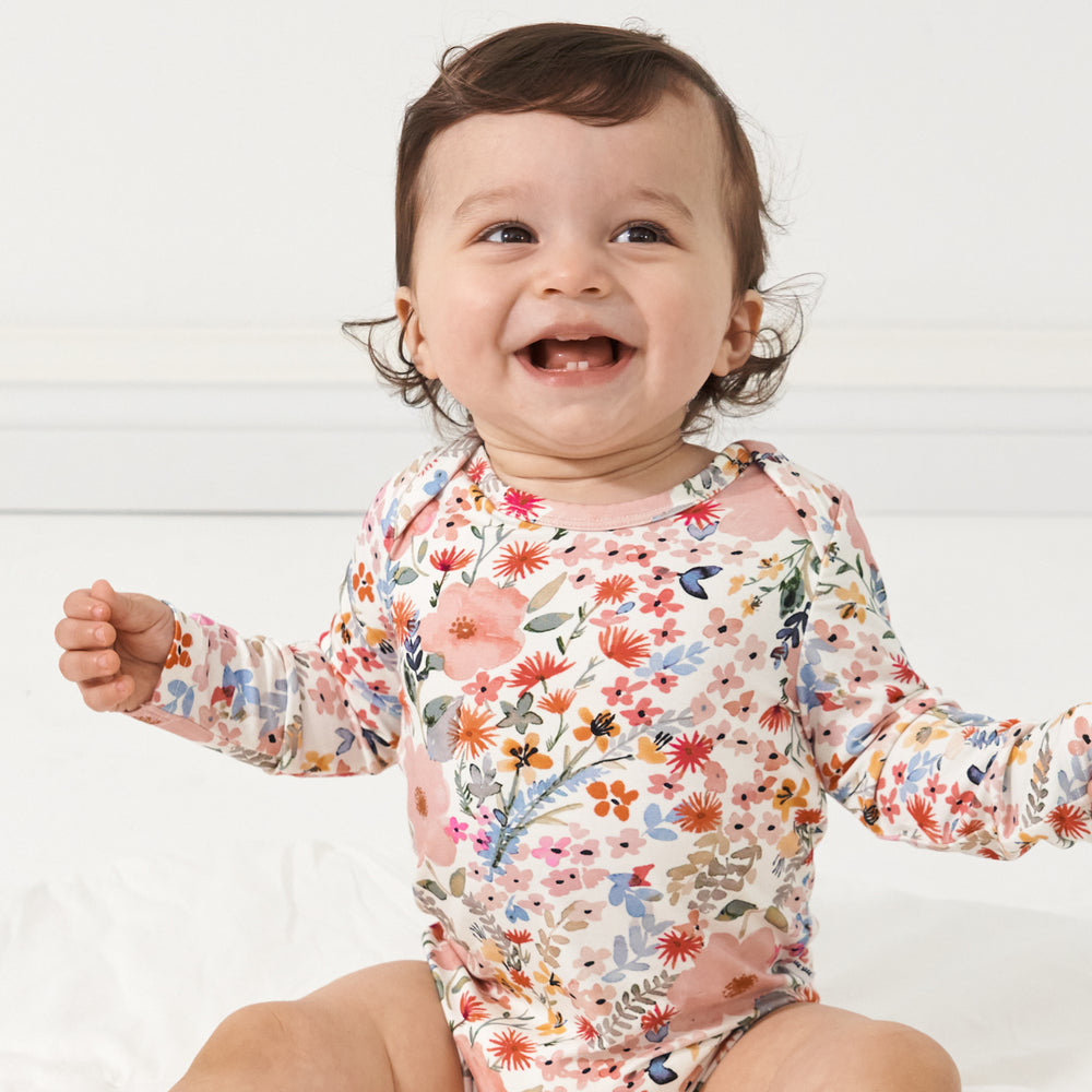 Alternative close up image of a child wearing a Mauve Meadow printed bodysuit