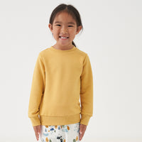 Alternate image of a child wearing a Honey elbow patch crewneck