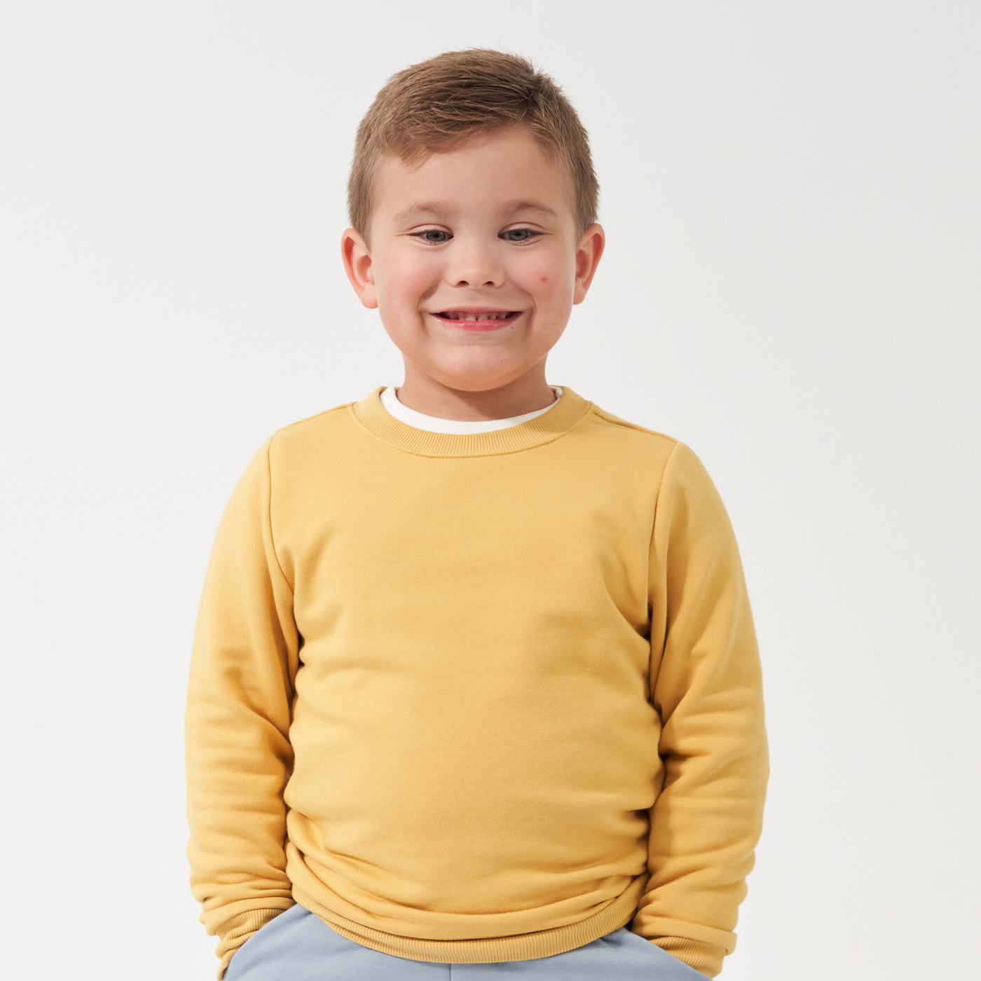 Child wearing a Honey elbow patch crewneck