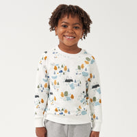 Child wearing a Let's Explore printed crewneck sweatshirt