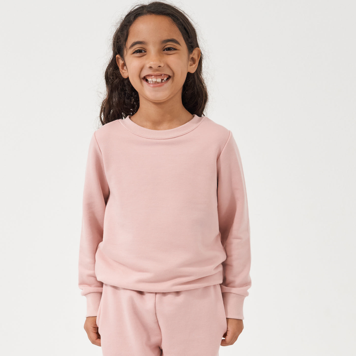 Child wearing a Mauve Blush crewneck paired with matching Mauve Blush paperbag joggers