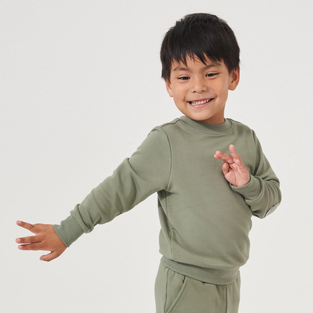 Child wearing a Moss elbow patch crewneck and matching joggers