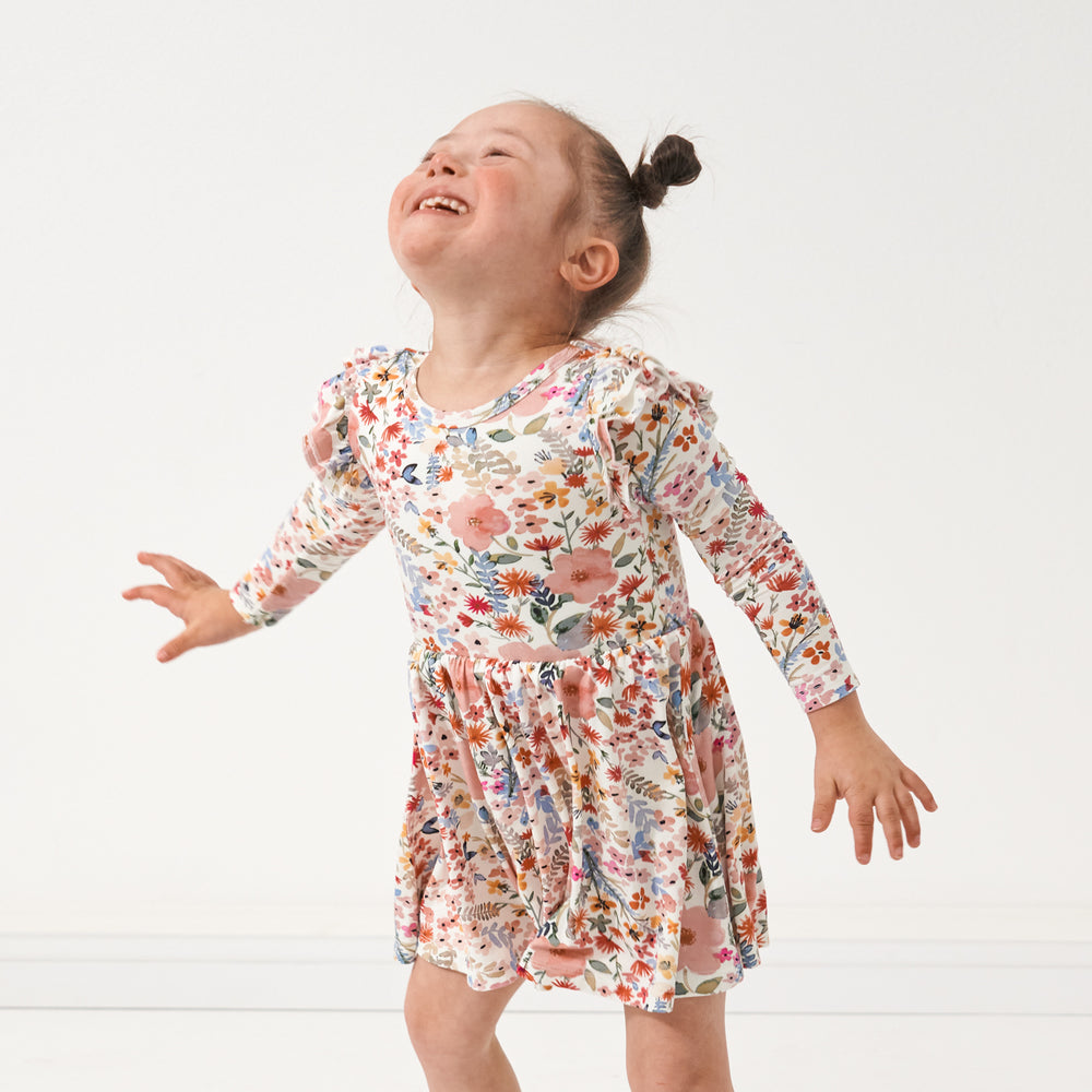 Click to see full screen - Child twirling wearing a Mauve Meadow twirl dress with bodysuit