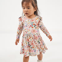 Child wearing a Mauve Meadow twirl dress with bodysuit
