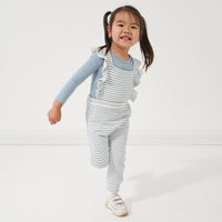 Child wearing a Fog bodysuit and coordinating Fog Stripes overalls