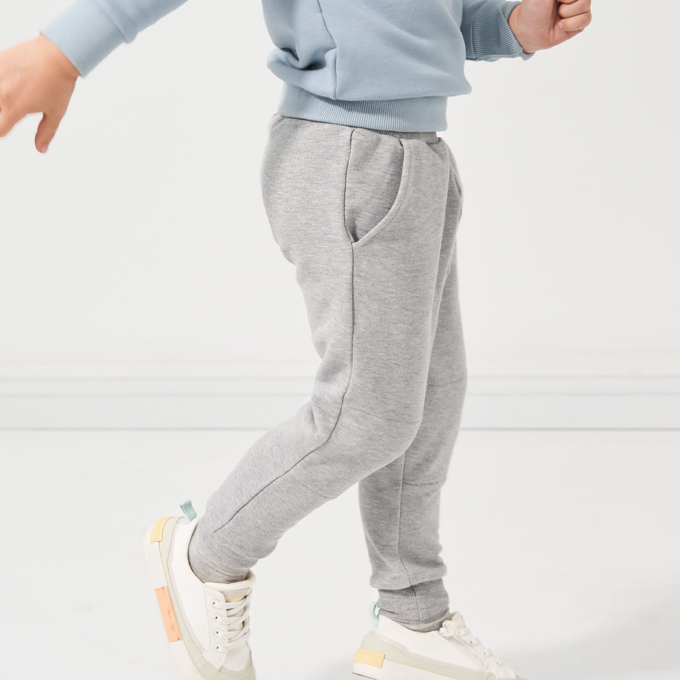 Child showing off the profile view of Heather Gray joggers