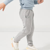 Child showing off the profile view of Heather Gray joggers