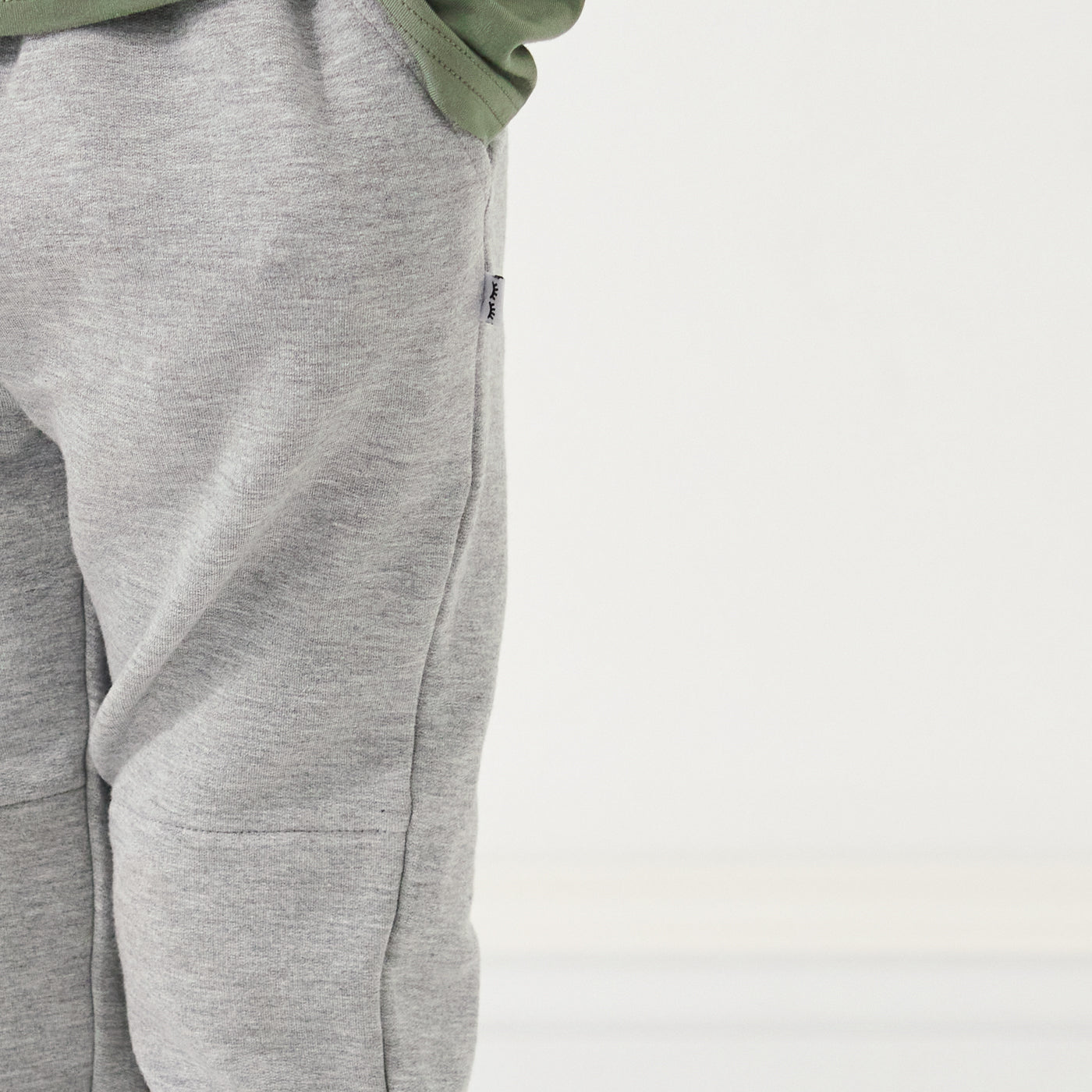 Close up image of the pockets and side hem of the Heather Gray joggers