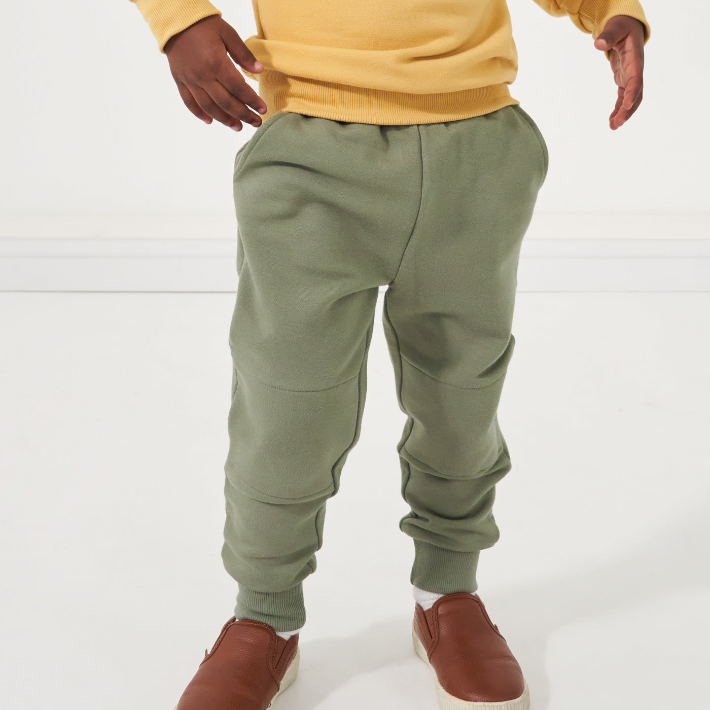 Close up image of a child wearing Moss joggers