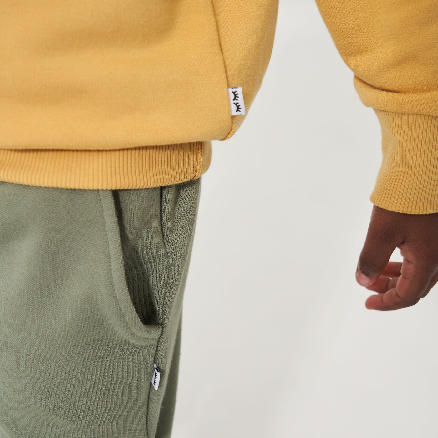 Close up image of a child wearing Moss joggers detailing the pocket