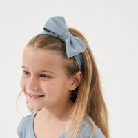 Child wearing a Fog luxe bow headband