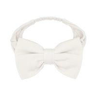 Flat lay image of an Ivory luxe bow headband in sizes age 4 to age 8