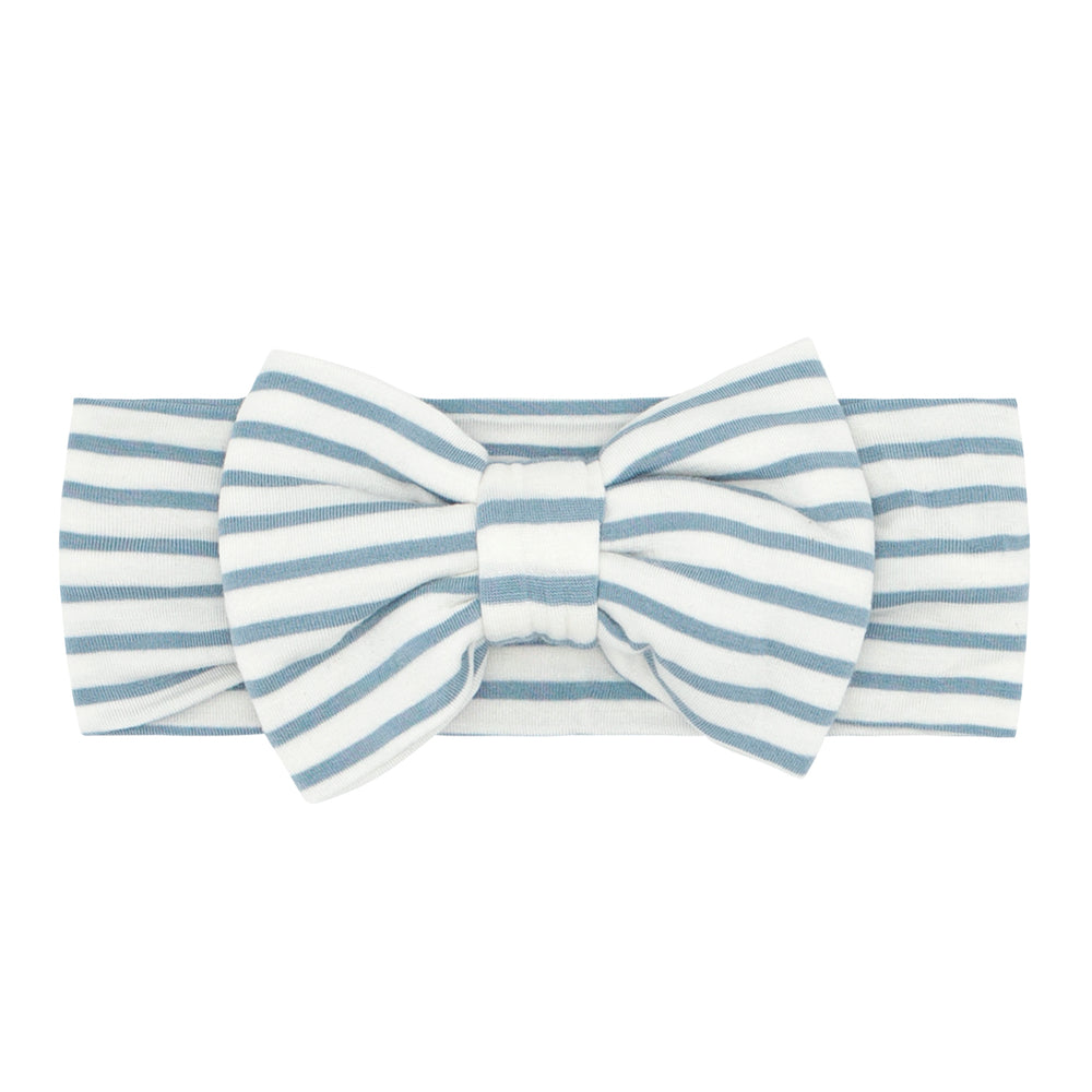 Flat lay image of an Ivory and Fog Stripe luxe bow headband 