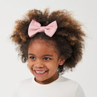 Child wearing a Mauve Blush luxe bow headband