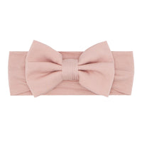 Flat lay image of a Mauve Blush luxe bow headband size newborn to 3T