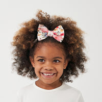 Child wearing a Mauve Meadow printed luxe bow headband