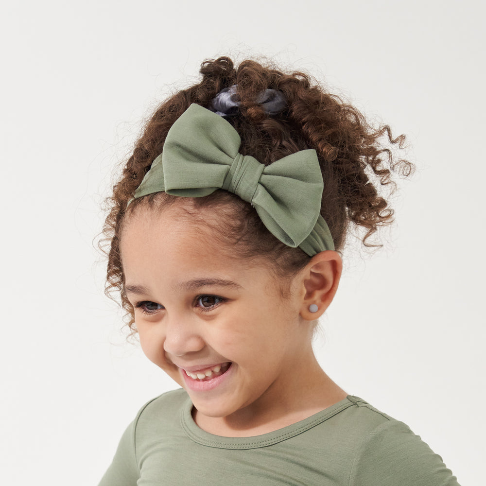 Click to see full screen - Child wearing a Moss luxe bow headband