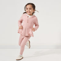 Child running wearing a Mauve Blush peplum hoodie paired with matching Mauve Blush leggings