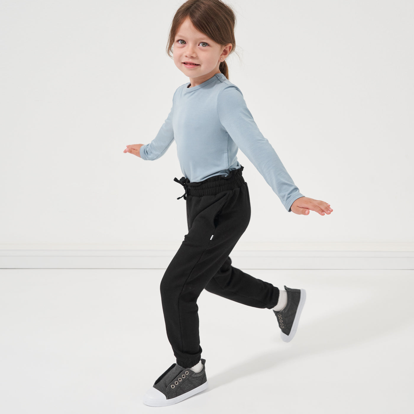 child playing wearing Black Paperbag Joggers paired with a Fog Classic Tee