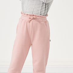 Close up image of a child wearing Mauve Blush paperbag joggers and coordinating Play top