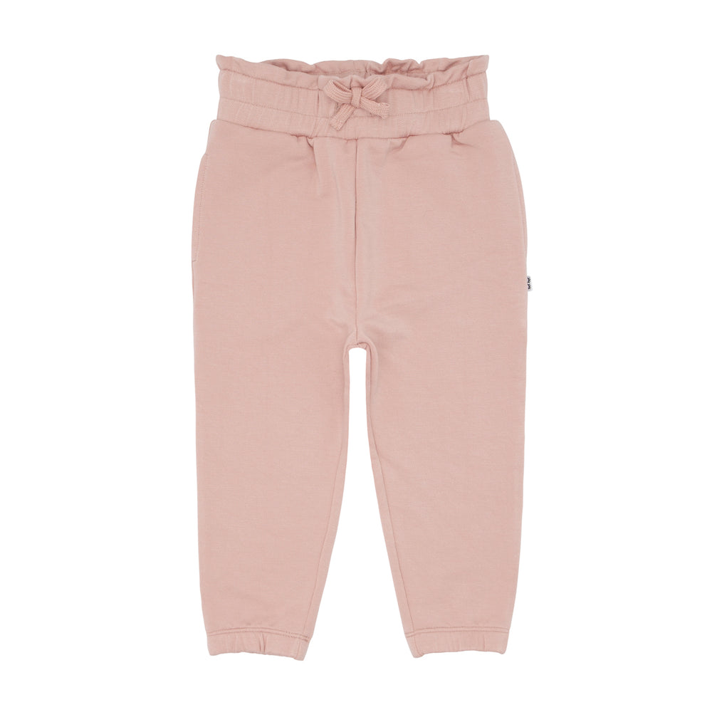 Click to see full screen - Flat lay image of a pair of Mauve Blush paperbag joggers
