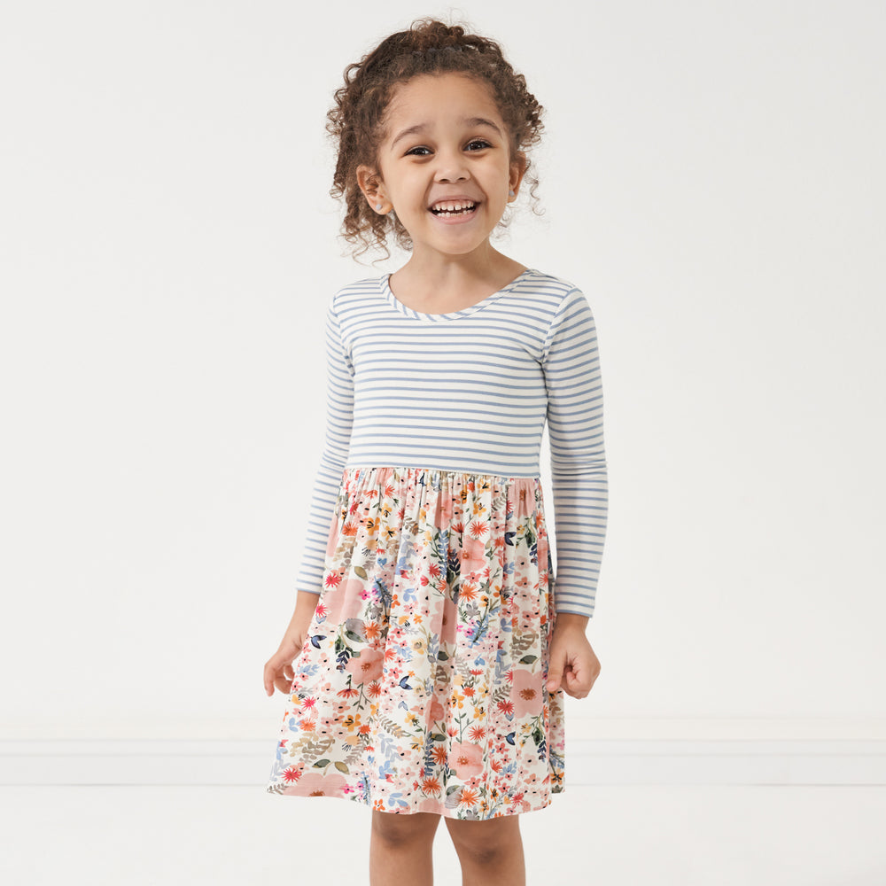 Click to see full screen - Child wearing an Ivory Fog Stripe and Mauve Meadow skater dress