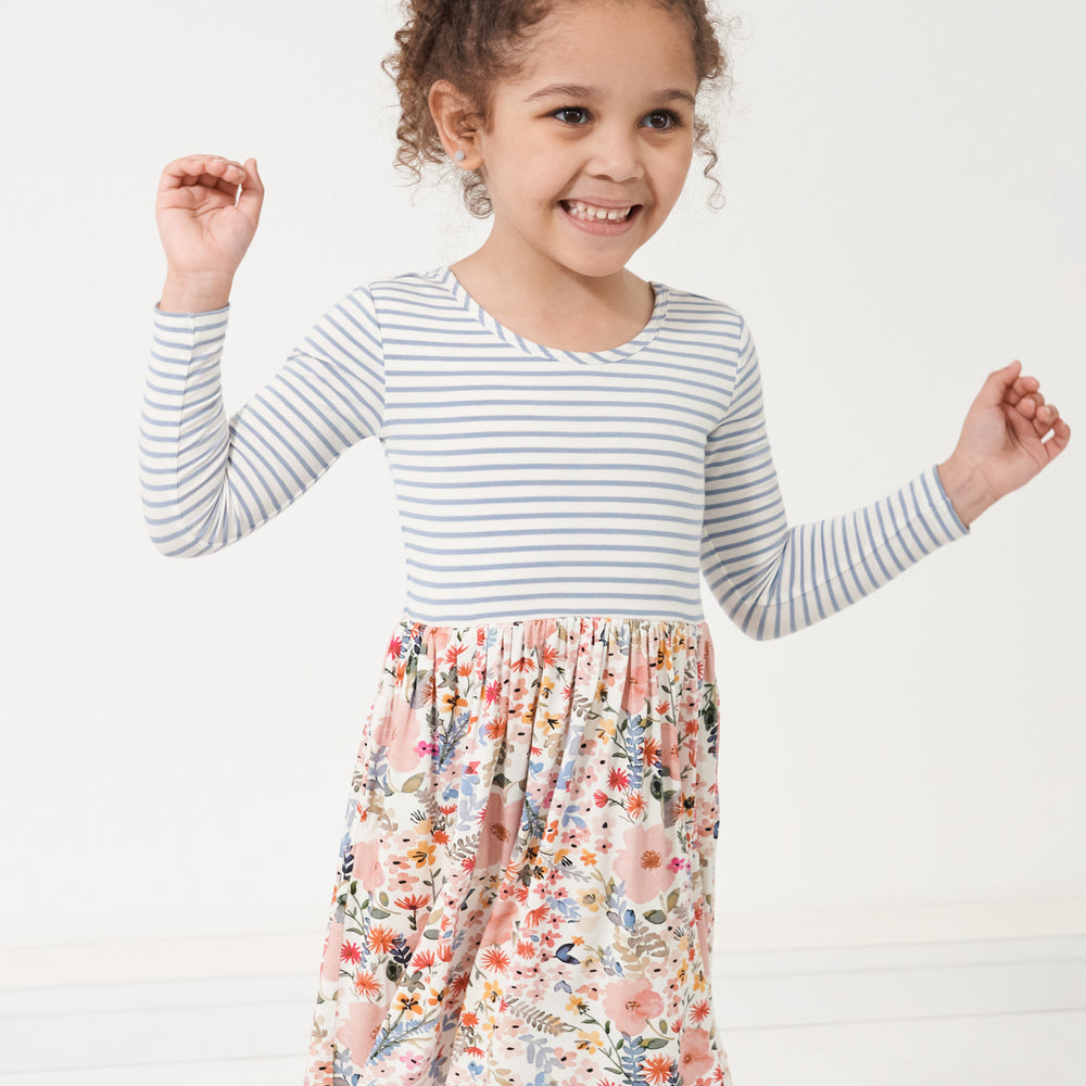 Click to see full screen - close up image of a child wearing an Ivory and Fog Stripe and Mauve Meadow skater dress detailing the bodice 