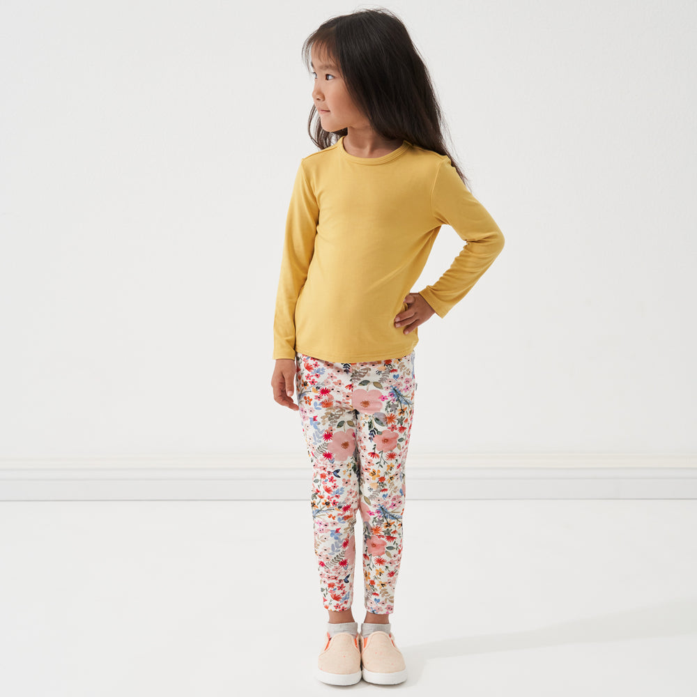 Child standing with their hand on their hip wearing a Honey classic tee and coordinating leggings
