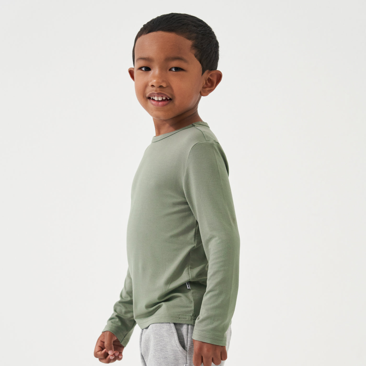 Side view image of a child wearing a Moss classic tee