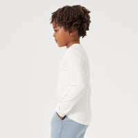 profile image of a child wearing an Ivory classic tee paired with Fog joggers