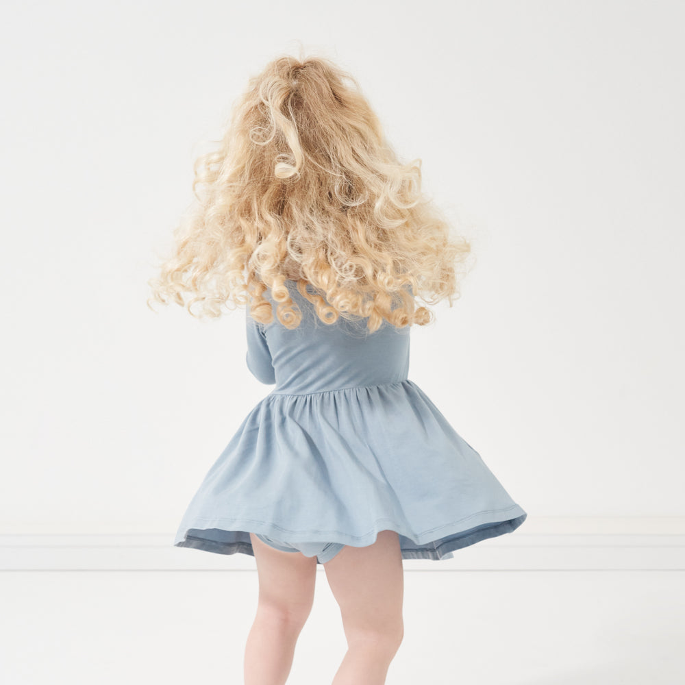Click to see full screen - Back view image of a child spinning around wearing a Fog twirl dress with bodysuit