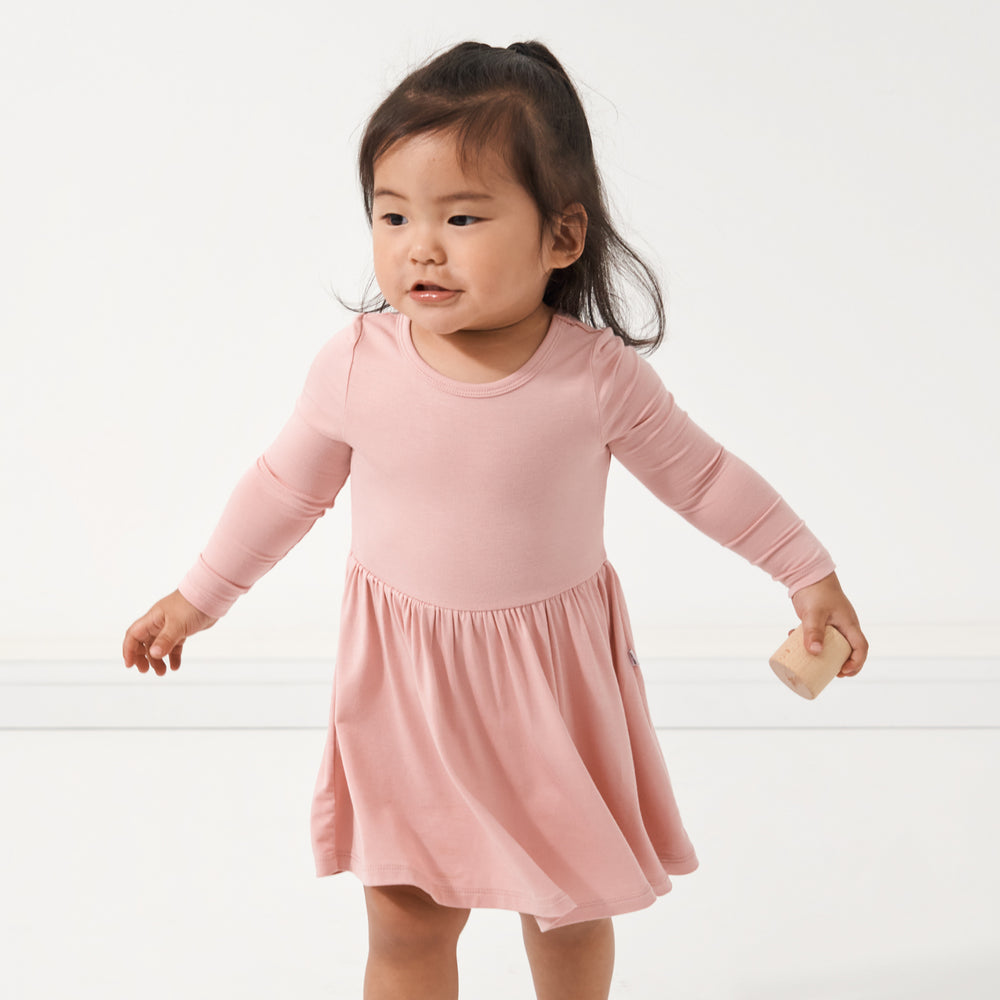 Child wearing a Mauve Blush twirl dress with bodysuit