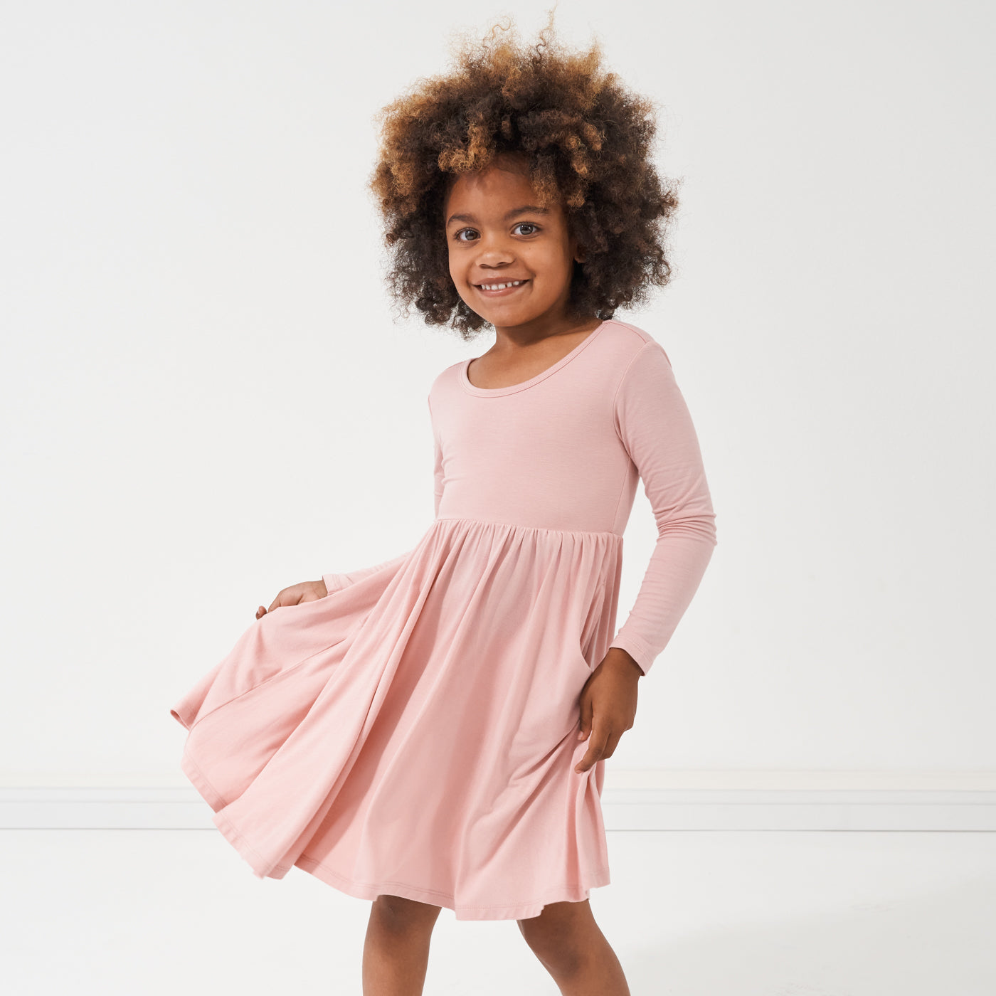 child dancing wearing a Mauve Blush twirl dress