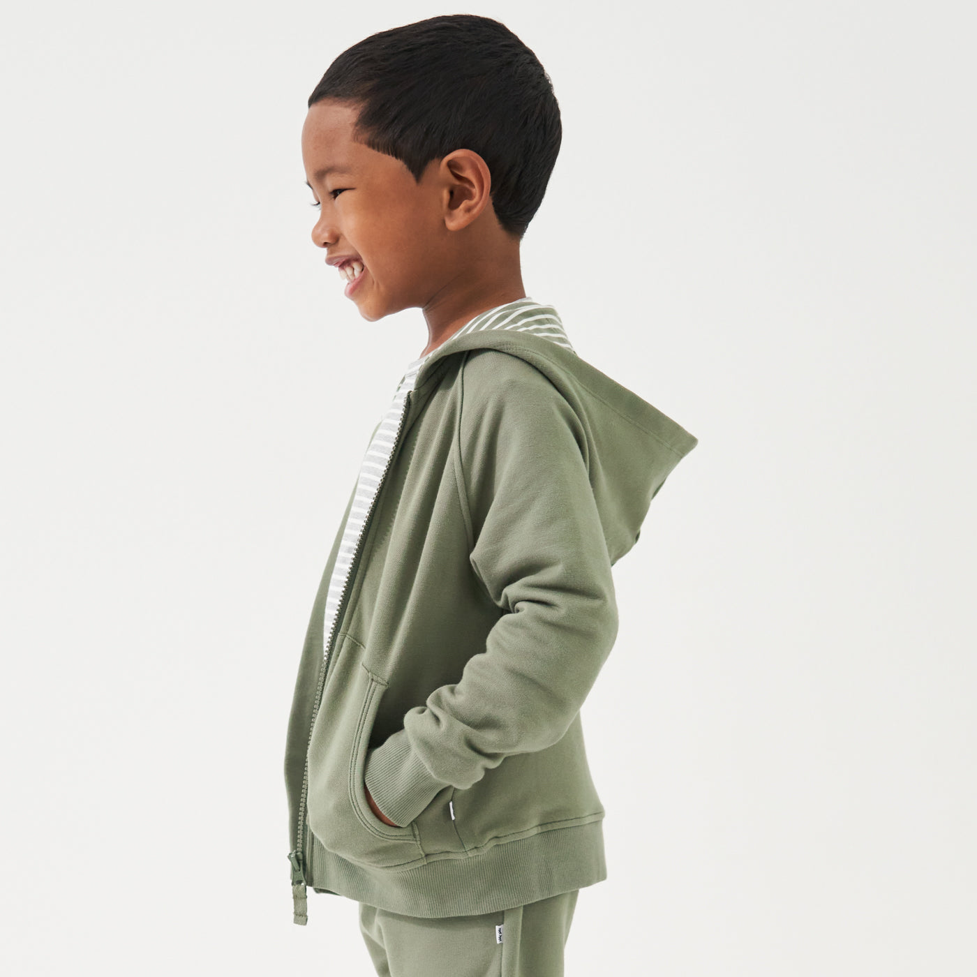 Side view image of a child wearing a Moss zip hoodie