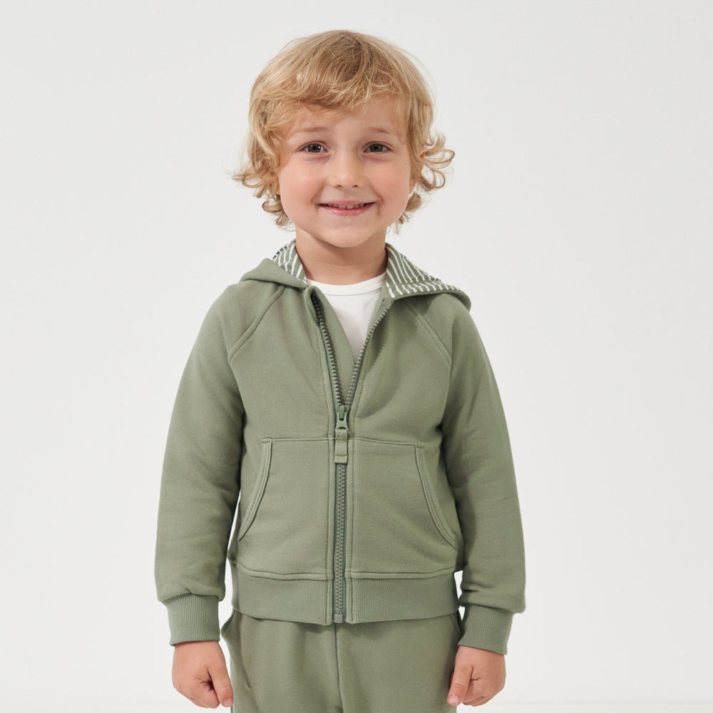 Child wearing a Moss zip hoodie