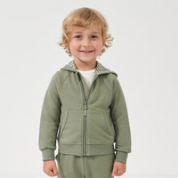 Child wearing a Moss zip hoodie