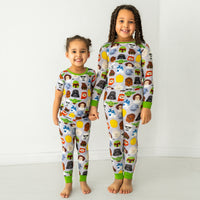 Two children holding hands wearing matching Legends of the Galaxy pajamas
