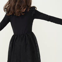 Back view image of a child wearing a Black flutter tutu dress