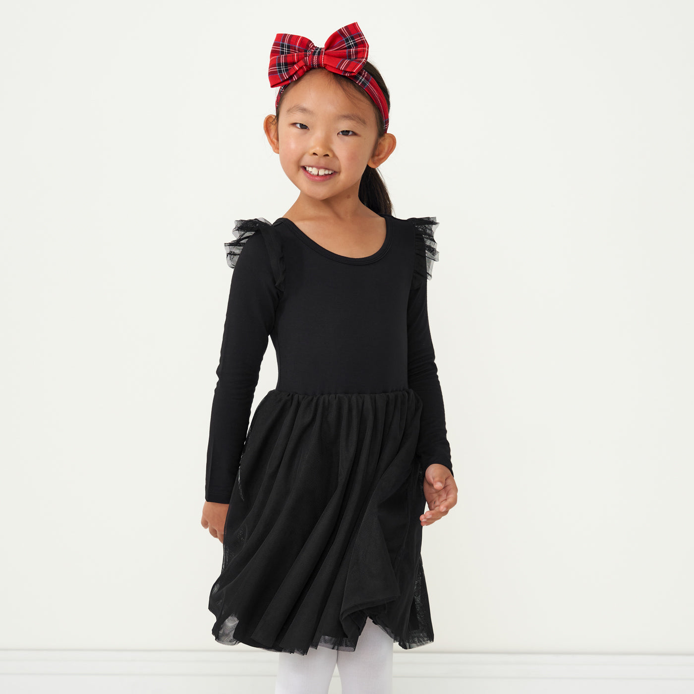 Alternate image of a child wearing a Black flutter tutu dress and coordinating Holiday Plaid luxe bow headband