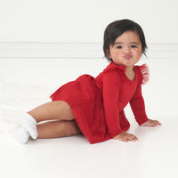 Child posing wearing a Holiday Red flutter tutu dress with bloomer
