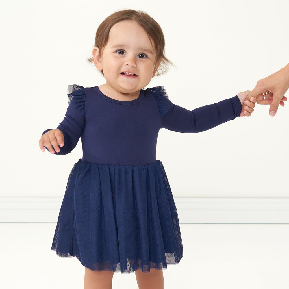 Close up image of a child wearing a Classic Navy flutter tutu dress with bloomer