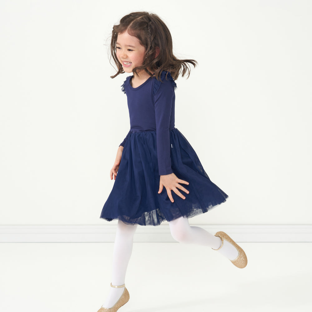 Child jumping wearing a Classic Navy flutter tutu dress