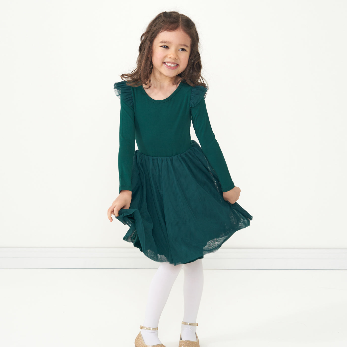 Child posing wearing an Emerald flutter tutu dress 