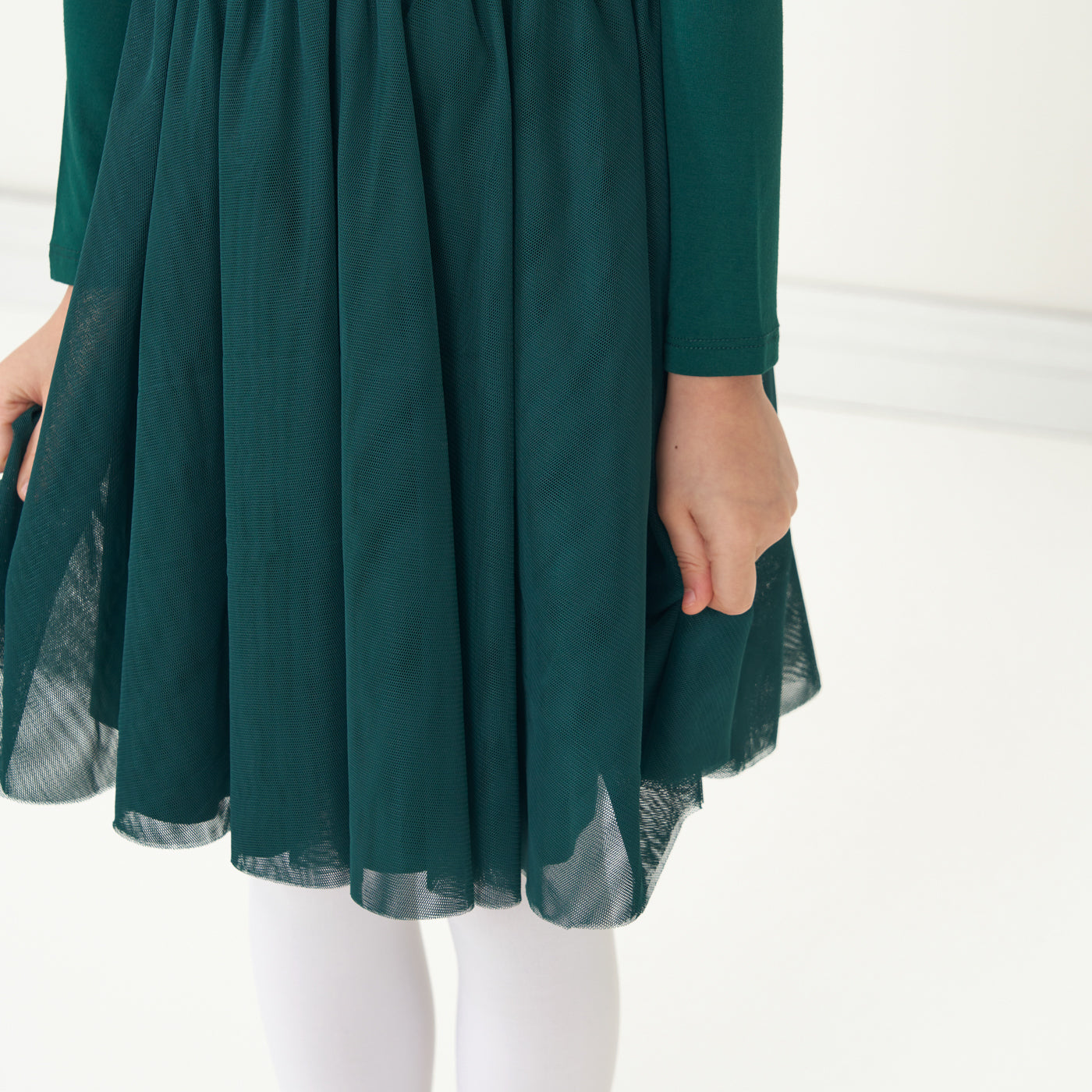 Close up image of a child wearing an Emerald flutter tutu dress showing off the tutu skirt