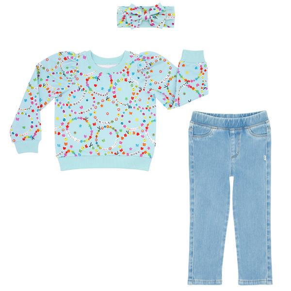 Flat lay composite of a Friends Forever Puff Sleeve Crewneck and Luxe Bow Headband and Light Blue Denim Jegging