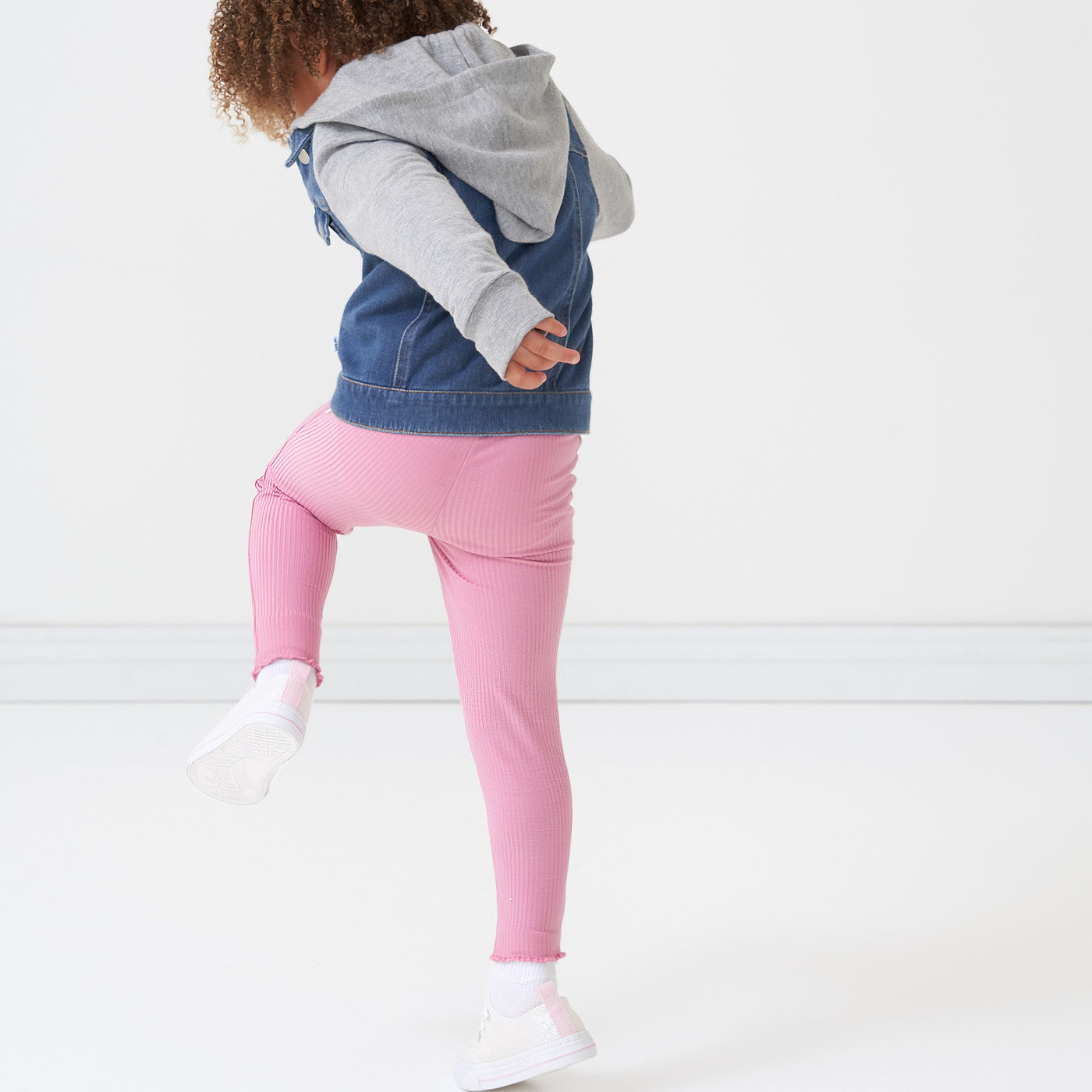 Child playing wearing a Garden Rose ribbed lettuce legging paired with a jean jacket 