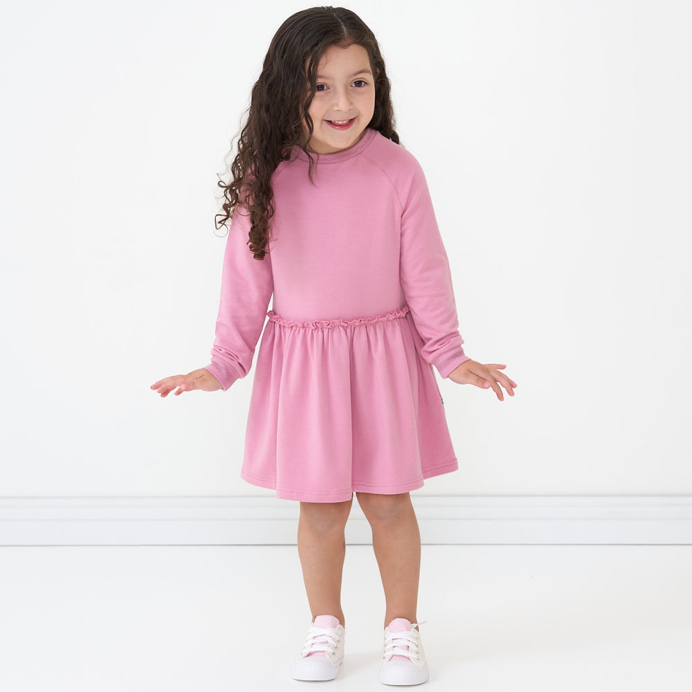 Child posing wearing a Garden Rose drop waist dress