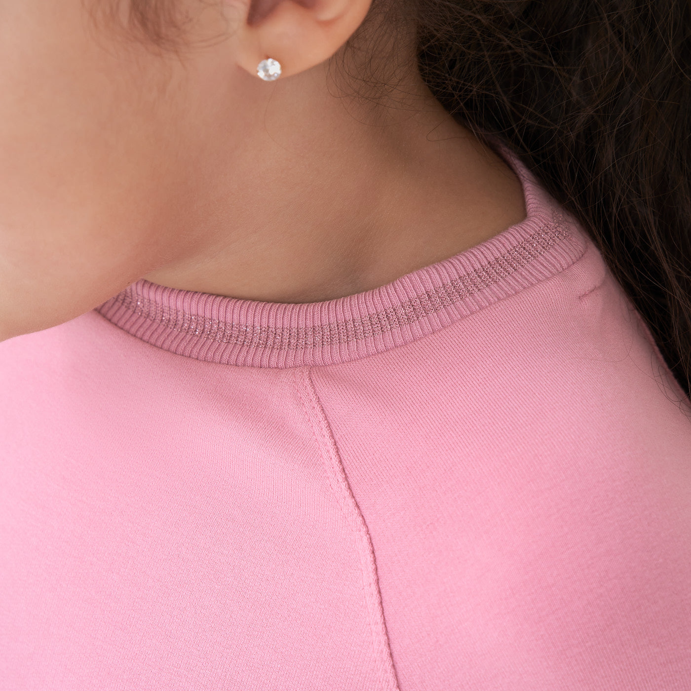 Close up image of a child wearing a Garden Rose drop waist dress focusing on the neckline