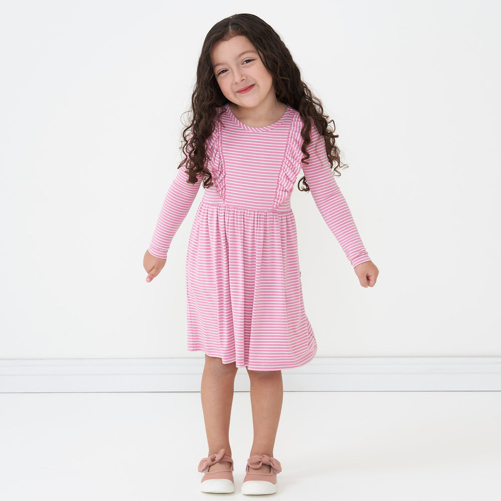 Alternate image of a child posing wearing a Garden Rose Stripes ruffle bib skater dress